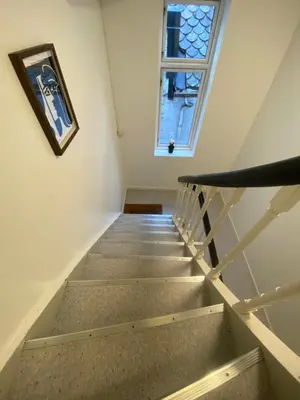 a staircase in a house with a window at Modern apartment on Bryggen Walking distance to everything! in Bergen