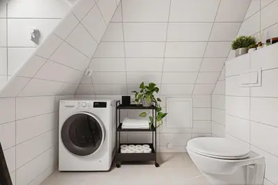 a bathroom with a washing machine and a toilet at Modern apartment on Bryggen Walking distance to everything! in Bergen