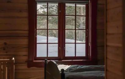 a window in a log cabin with snow outside at Gorgeous Apartment In Bjorli With House A Panoramic View in Bjorli