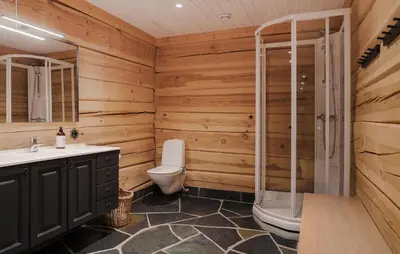 a wooden bathroom with a toilet and a shower at Gorgeous Apartment In Bjorli With House A Panoramic View in Bjorli