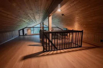an empty room with a staircase in a wooden building at Luxury cabin, Wellness and view over the Tyrifjord in Vikersund