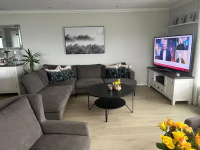 a living room with a couch and a tv at House with oceanview, 4 bedrooms, close to Bergen in Alversund