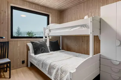 a bedroom with a bunk bed and a window at Vestbyvegen 34A By Vacation Trysil in Trysil