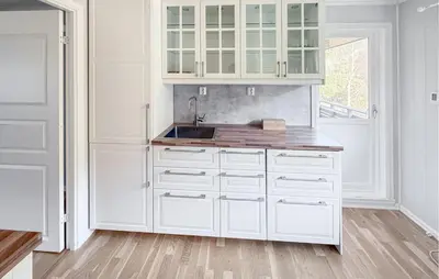 a white kitchen with white cabinets and a sink at Beautiful Home In Kvammen With House A Panoramic View in Kvammen