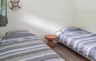 two beds sitting next to each other in a bedroom at Beautiful Home In Kvammen With House A Panoramic View in Kvammen