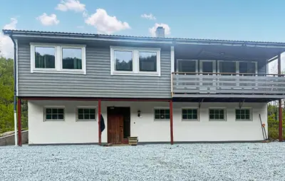 a large house with a lot of windows at Beautiful Home In Kvammen With House A Panoramic View in Kvammen