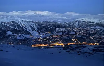 an aerial view of a city at night with snow covered mountains at Lovely Home In Bjorli With Sauna in Bjorli