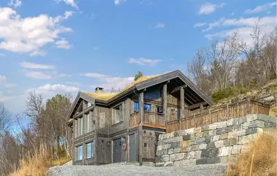 a house with a grass roof on top of it at Lovely Home In Bjorli With Sauna in Bjorli