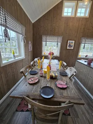 a dining room table with chairs and a wooden tableablish at Cozy Cabin Retreat in Fl, Norway - Perfect for Families and Nature Lovers in Flå