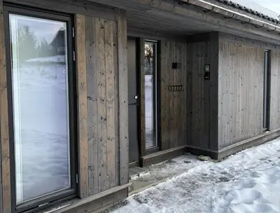 a wooden house with windows in the snow at Gemütliche Hütte in traumhafter Natur auf 1000 m in Ål