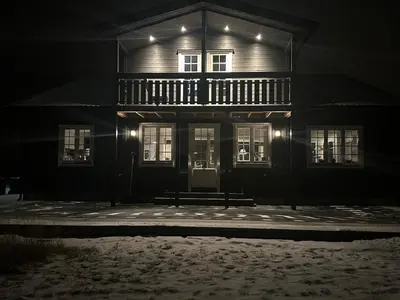 a house at night with a bench in front of it at Bolig sentralt på Røros in Røros