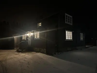 a house lit up at night with lights on it at Bolig sentralt på Røros in Røros