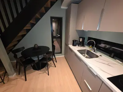 a kitchen with a sink and a table with chairs at House with great location in Trysil