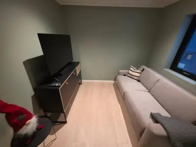 a living room with a couch and a flat screen tv at House with great location in Trysil