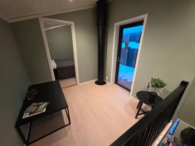 a living room with a table and a door to a bedroom at House with great location in Trysil