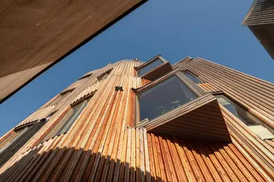 a building with a brown roof with windows on it at Stylish apt 2nd floor city centre in Trondheim