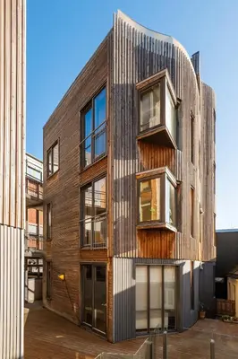 an office building with a wooden facade at Stylish apt 2nd floor city centre in Trondheim