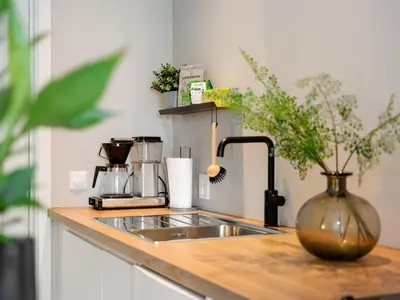 a kitchen counter with a sink and a vase at 3FF - Newly renovated studio apt in the middle of the city centre in Trondheim