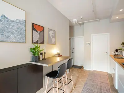 a kitchen with a desk and two chairs at 3FF - Newly renovated studio apt in the middle of the city centre in Trondheim