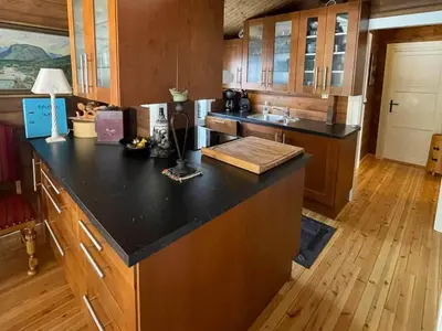 a kitchen with a black counter top in a room at 8 person holiday home in Jordet in Jordet
