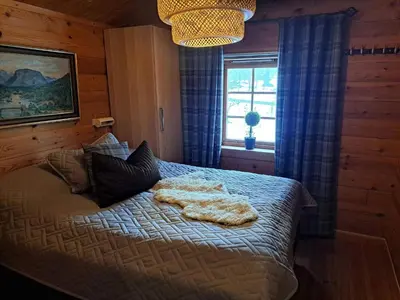 a bedroom with a bed with a blanket on it at 8 person holiday home in Jordet in Jordet