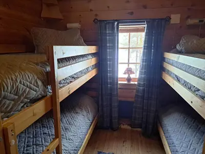 two bunk beds in a room with a window at 8 person holiday home in Jordet in Jordet