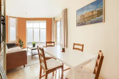 a living room with a white table and chairs at Elegant 1-Bed Apt in City Centre in Trondheim
