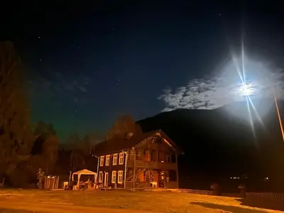 a house at night with a street light next to it at Charming Guesthouse farm in Hølera