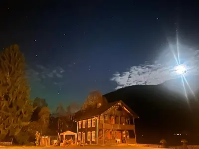a light on top of a house at night at Charming Guesthouse farm in Hølera