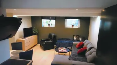 a living room with a couch and a table at Apartament Vigra Fjord in Synes