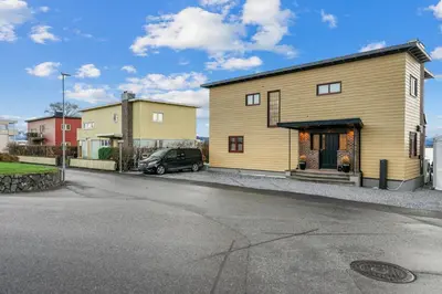 a house with a car parked in front of it at Grand Junior Suite in Molde