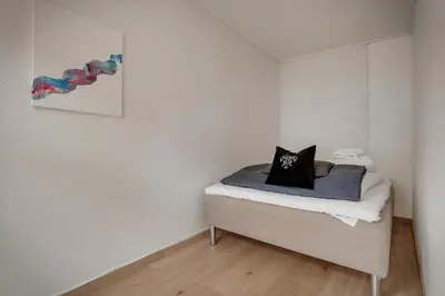 a bedroom with a bed with a pillow on it at 3 soverom, sentralt i Bergen og moderne bad in Bergen