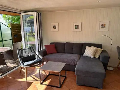 a living room with a couch and a table at 4 person holiday home in Eidsvåg in Eidsvåg