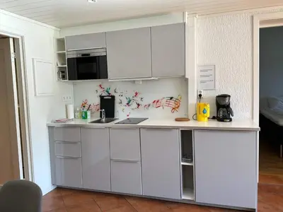 a kitchen with white cabinets and a counter top at 4 person holiday home in Eidsvåg in Eidsvåg
