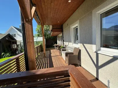 a porch of a home with a wooden deck at 4 person holiday home in Eidsvåg in Eidsvåg
