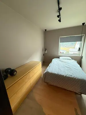 a bedroom with a bed and a window at Nyoppusset leilighet til leie in Isfjorden