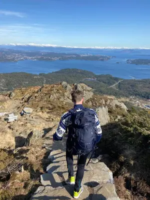 a man standing on the edge of a mountain at Siggjo Guesthouse Bømlo and Stord in Mosterhamn