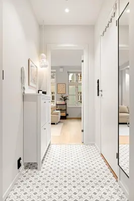 a hallway with white walls and a white floor at Perfect Location by Bryggen in Bergen