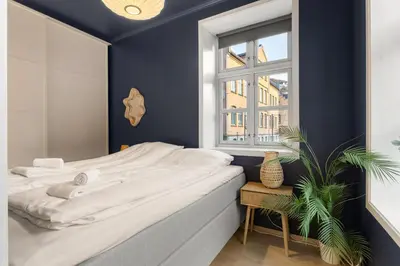 a bedroom with a white bed and a window at Perfect Location by Bryggen in Bergen