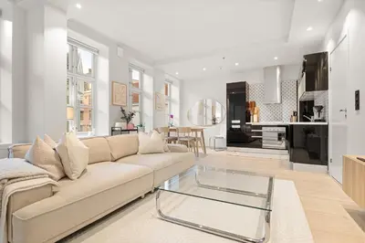 a living room with a couch and a glass table at Perfect Location by Bryggen in Bergen