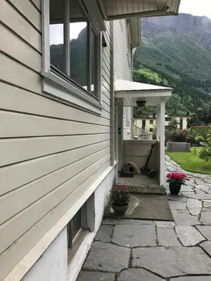 a side of a house with a window and flowers at Near Trolltunga and centre of Odda in Odda
