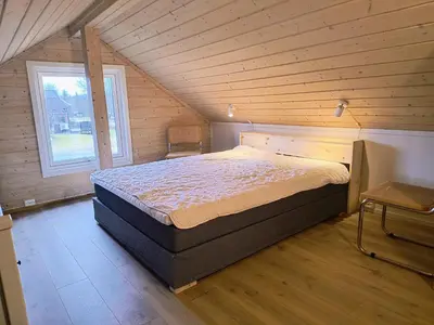 a bedroom with a bed in a wooden cabin at Ullabu in Gol
