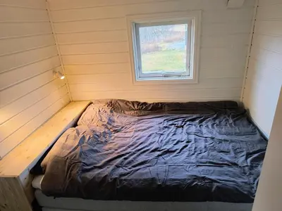 a bed in a small room with a window at Ullabu in Gol