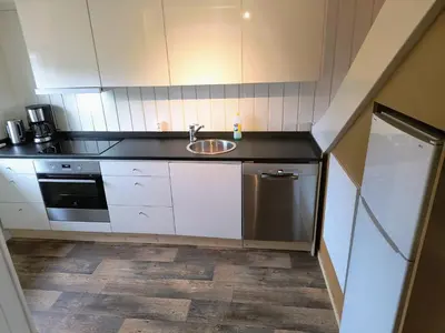 a small kitchen with a sink and a dishwasher at Ullabu in Gol