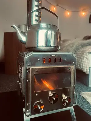 a stove with a pot on top of it at Torshaug glamping in Trondheim