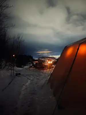 a car parked in the snow at night at Torshaug glamping in Trondheim