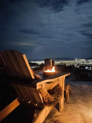 a wooden bench with a lit up candle on top of it at Torshaug glamping in Trondheim