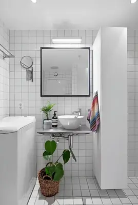 a white bathroom with a sink and a mirror at Studio apartment in city center in Bergen