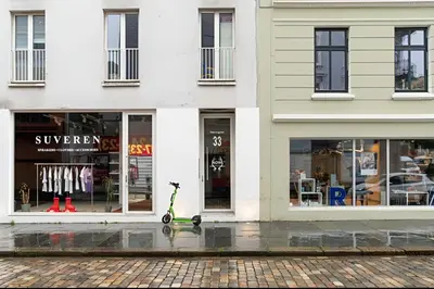 a scooter is parked in front of a store at Studio apartment in city center in Bergen
