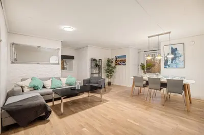 a living room with a couch and a table at Bergen city center Kalfaveien in Bergen